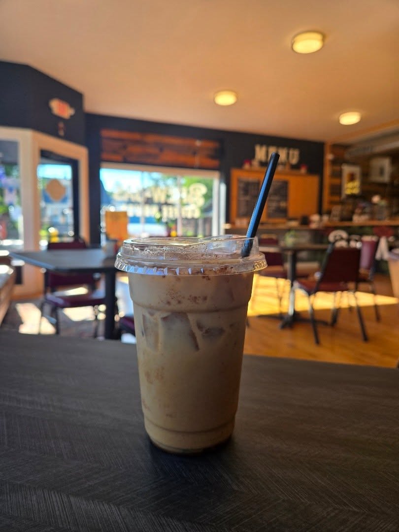 Iced coffee on a table inside Brew-Jas Coffee House